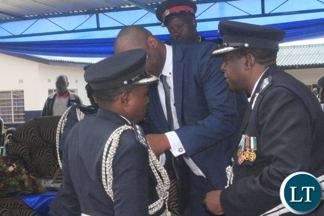 Copperbelt Minister, Bowman Lusambo unveiling medals given to deserving Police Officers during 'Police Day' at Kamfinsa School of Meintenance in Kitwe