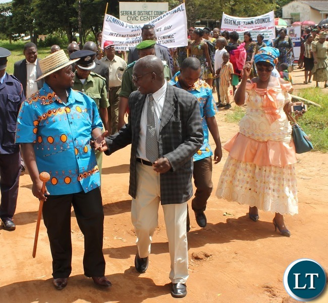 Serenje District Commissioner Fracis Kalipenta (Centre), Serenje District Council Secretary Pamela Zulu (Right) and Serenje District Council Chairperson Chester Kasonde (Left) lead marchers to the National square where this year’s district International Women’s Day was commemorated from.