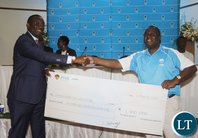 FAZ President Andrew Kamanga receiving from FNB Chief Financial Officer Ackim Mwale a dummy cheque worth of K1,5 million during the MOU signing ceremony between FAZ and FNB art Lusaka Taj Pamodzi Hotel. FNB has made a sponsorship deal with FAZ for U20 that will last for 3 years.Picture by Jean Mandela FAZ President Andrew Kamanga receiving from FNB Chief Financial Officer Ackim Mwale a dummy cheque worth of K1,5 million during the MOU signing ceremony between FAZ and FNB art Lusaka Taj Pamodzi Hotel. FNB has made a sponsorship deal with FAZ for U20 that will last for 3 years.Picture by Jean Mandela