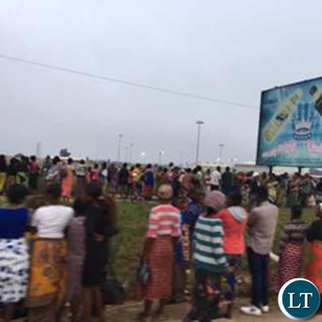 People gather for free food parcels