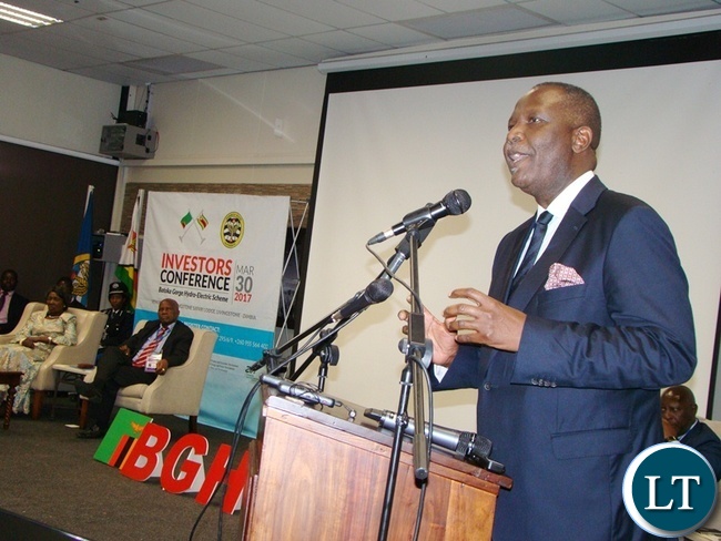 FINANCE Minister Felix Mutati gives his speech during the official opening of the Batoka Gorge Hydroelectric Power, Investors Conference at David Livingstone Safari Lodge in Livingstone yesterday. Far left sited are Vice President Inonge Wina (l) and Zimbabwean Finance and Economic Development Patrick Chinamasa.