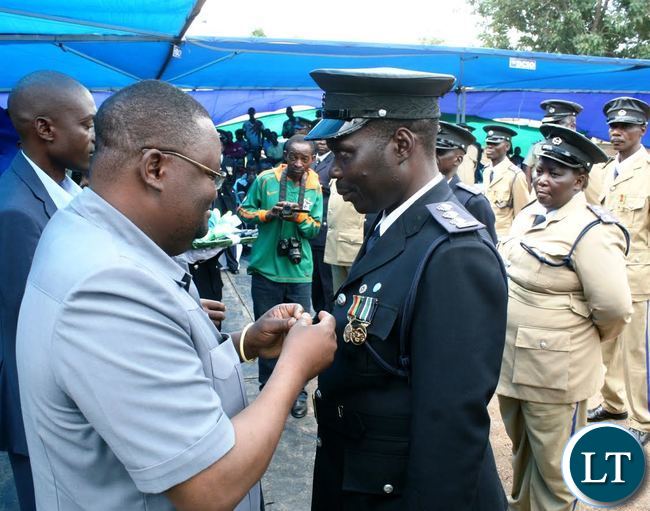 LUAPULA Province Permanent Secretary Dr. Buleti Nsemukila conferring a medal of bravery to Assistant Superintendent Phiri Admarks during the Zambia Police Open Day cerebration in Mansa over the weekend.
