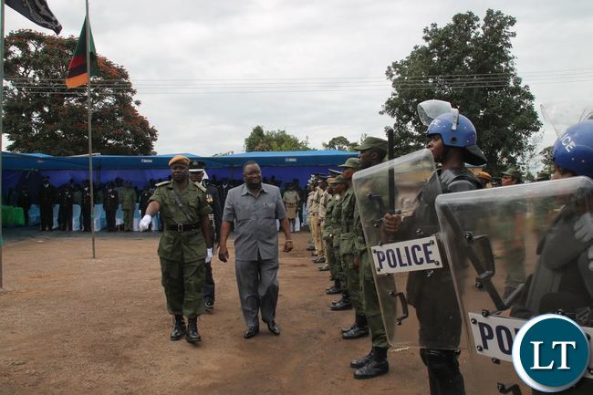 LUAPULA Province Permanent Secretary Dr. Buleti Nsemukila( in a grey suit) inspecting a guard of honor during the Zambia Police Service Open Day commemoration