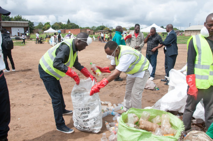 Kapwepwe Ward 25 councillor Patrick Mwamba Salubusa and Zambian Breweries Corporate Affairs director Ezekiel Sekele join in the Chunga clean up in Lusaka.