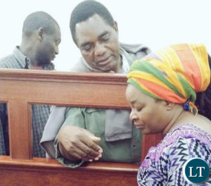 Mr Hichilema counsels his wife Mutinta in court this morning.