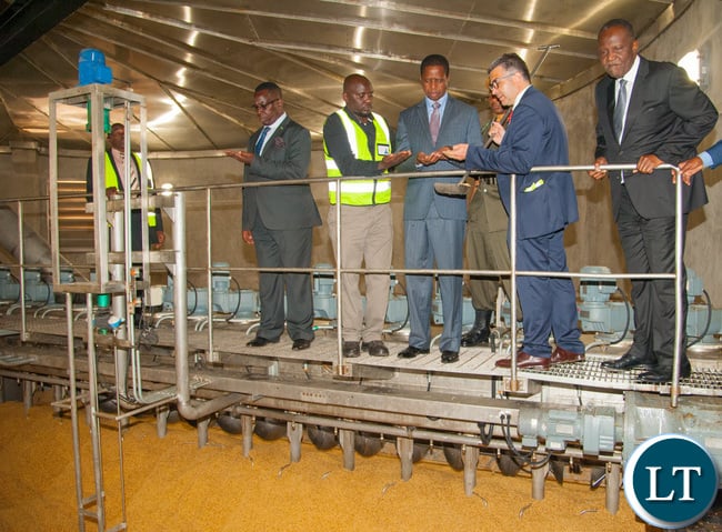 President Edgar Chagwa Lungu and Finance Minister Hon. Felix Mutati inspect barley at Zambian Breweries' new US$33 million malting plant with Zambian Breweries Operations Director Franz Schepping.