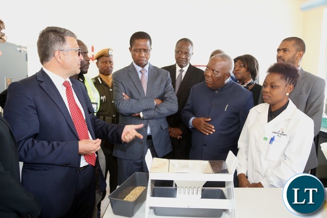 President Edgar Lungu listerns to Zambia breweries Technical and Supply Chain Director Franz Schepping during the commissioning of the malting plant in Lusaka South Multi-facility Zone