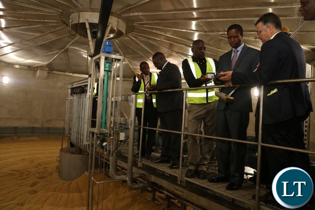 President Edgar Lungu listerns to Zambia breweries Technical and Supply Chain Director Franz Schepping during the tour and commissioning of the malting plant in Lusaka South Multi-facility Zone