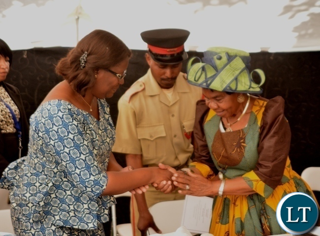 Minister in the Office of the Vice President Sylvia Chalikosa(l) congratulates Her Royal Highness Senior Chieftainess Nkomeshya Mukamambo II after giving her keynote speech at the Peace Corps Swearing in Ceremony for Environment and Aqua-Culture Volunteers in Lusaka