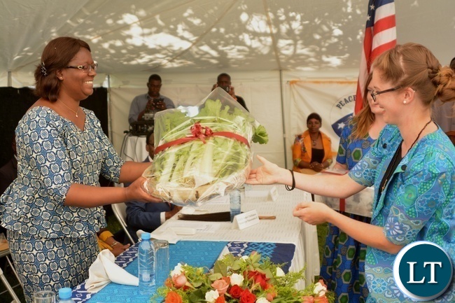 Peace Corp Volunteer Kathleen Parks(r) presents Vegetables as a gift of appreciation to the Minister in the Office of the Vice President Sylvia Chalikosa(l) at the Peace Corps Swearing in Ceremony for Environment and Aqua-Culture Volunteers in Lusaka