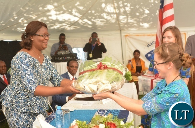 Peace Corp Volunteer Kathleen Parks(r) presents Vegetables as a gift of appreciation to the Minister in the Office of the Vice President Sylvia Chalikosa(l) at the Peace Corps Swearing in Ceremony for Environment and Aqua-Culture Volunteers in Lusaka