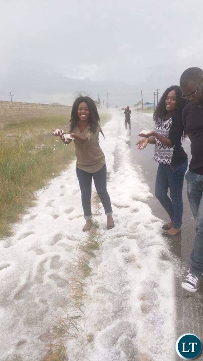 Excited Lusaka residents playing in snow like hailstone