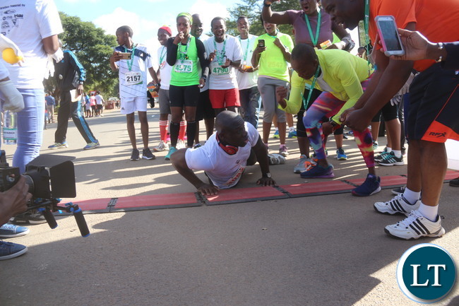 Lusaka 2017 Lafarge Marathon participant Presley Chiyesu crawling to the finishing line and he was rushed to the hospital during the even on Saturday at Lusaka Levy junction. Picture by Jean Mandela