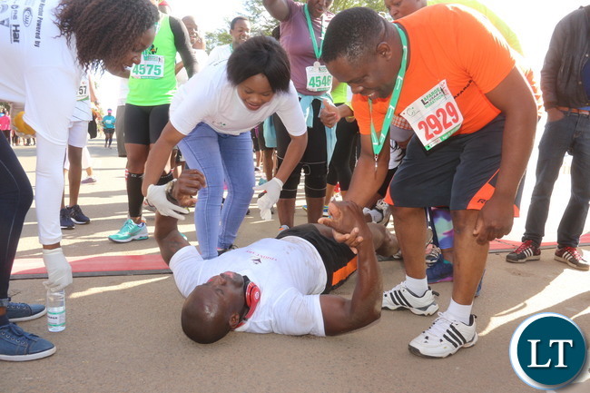 Lusaka 2017 Lafarge Marathon participant Presley Chiyesu crawling to the finishing line and he was rushed to the hospital during the even on Saturday at Lusaka Levy junction. Picture by Jean Mandela