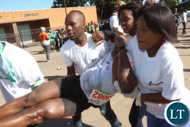 Lusaka 2017 Lafarge Marathon participant Presley Chiyesu crawling to the finishing line and he was rushed to the hospital during the even on Saturday at Lusaka Levy junction. Picture by Jean Mandela