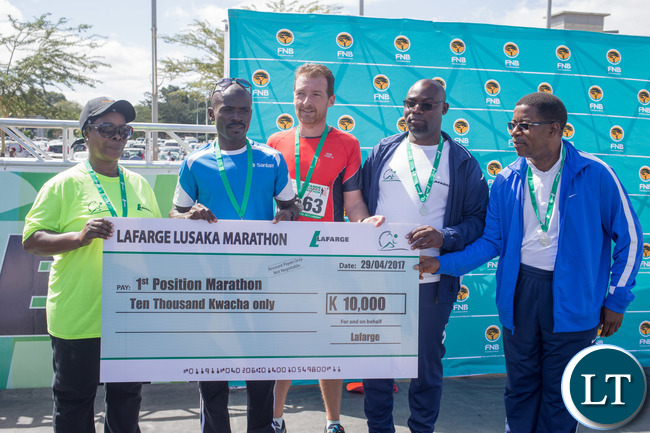 L-r, First Lady Madam Esther Lungu, Mathew Mutanya Marathon Winner , Lafarge CEO Vincent Bouckaert, The Minister of Youths and Sports Mr Moses Mawere and ZAAA president Mr Elias Mpondela