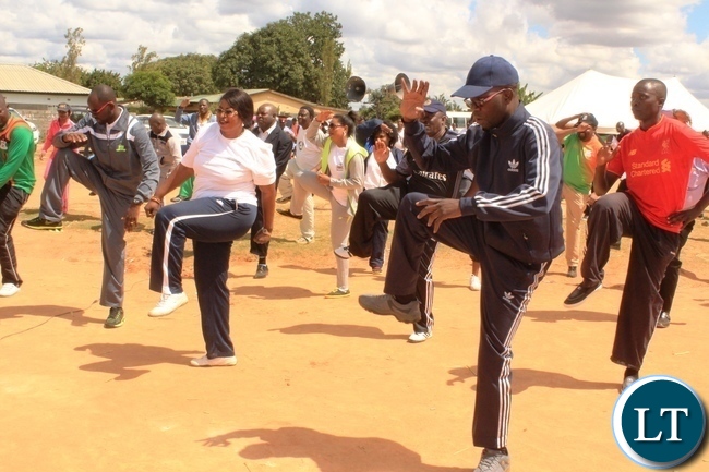 Copperbelt Province Permanent Secretary, Elias Kamanga leads heads of government departments in doing aerobics after he launched the National Health Week at Wusakile Ground in Kitwe on Monday. Left is Mufulira District Commissioner, Hilda Kabwesha and Kitwe District Commissioner, Binwell Mpundu