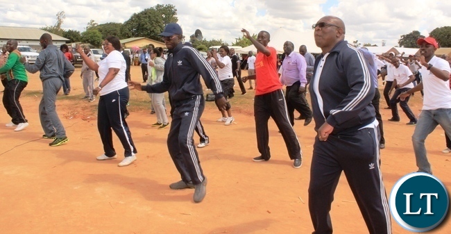 Copperbelt Province Permanent Secretary, Elias Kamanga leads heads of government departments in doing aerobics after he launched the National Health Week at Wusakile Ground in Kitwe