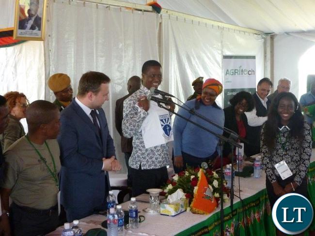 President Lungu holds up a t-shirt that Stephanie (r) gave to him at the Agritech official opening ceremony