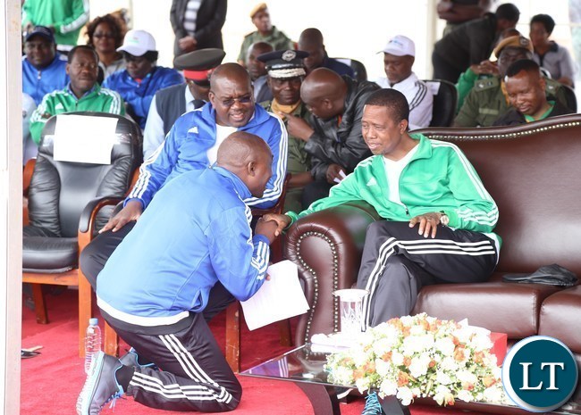 President Edgar Lungu confers with Lusaka Province Minister Japhen Mwakalombe during the official launch of the 2017 National Health Week at the Olympic Youth Development Centre