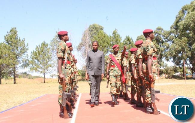 PRESIDENT Edgar Lungu inspecting a guard of honor on arrival at KARA Barracks in Kawambwa where Government is constructing 995 Housing units for the 48 Marine Commandos.