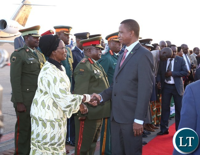 Vice President Inonge Wina welcomes President Edgar Lungu shortly after his arrival from Lesotho at Kenneth Kaunda International Airport