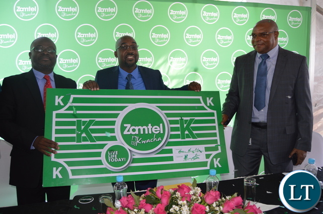 Transport and Communications Minister Brian Mushimba launches ZAMTEL Kwacha as ZAMTEL Acting Chief Executive Officer Sydney Mupeta (L) and Bank of Zambia Governor Denny Kalyalya (R) look on