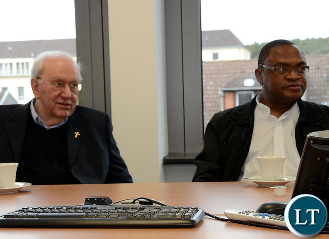 Father Paul Samasumo (L)