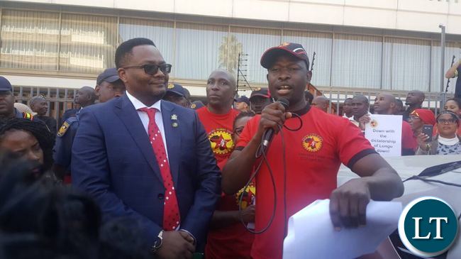 Emmanuel Mwamba listens to a representative of NUMSA