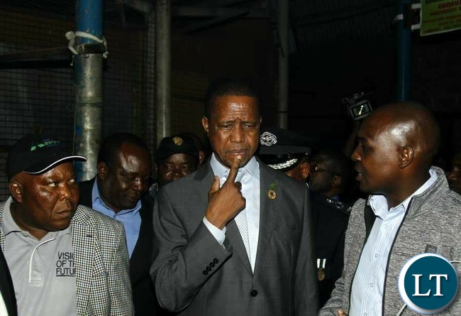 President Edgar Chagwa Lungu (centre) being briefed by Lusaka Province Minister Japhen Mwakalombe (right) when he visited City Market in Lusaka on Tuesday,July 4,2017. On the left is Presidential Affairs Minister Freedom Sikazwe. PICTURE BY SALIM HENRY/STATE HOUSE ©2017