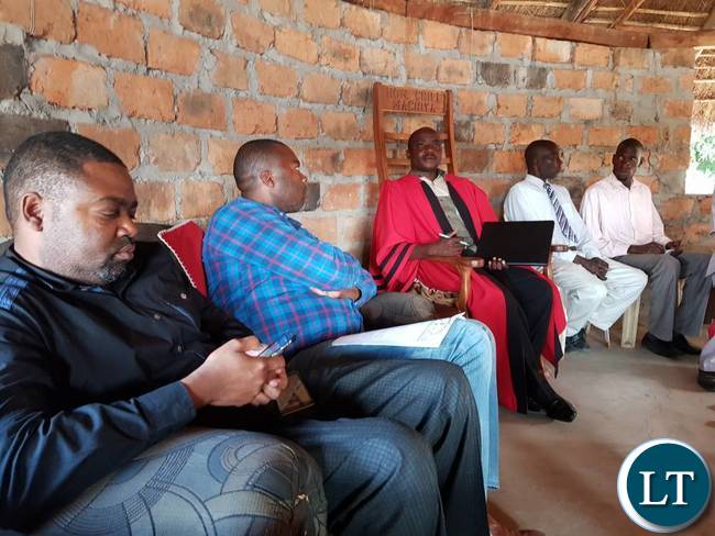 Mr. Lusambo is flanked by Mpongwe DC at Chief Machiya's palace