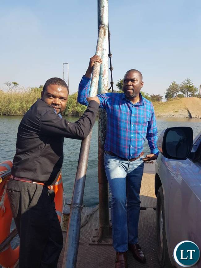 Mr. Lusambo on a ferry on the Kafue River heading to Chief Machiya's palace in Mpongwe
