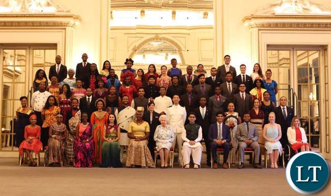 Natasha Salifyanji Kakoma sits next to Queen Elizabeth during a group photo