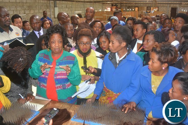 Minister of Labour Joyce Nonde talks to Eve’s Hair Production workers during the inspection of the Eve ’S factory in Lusaka yesterday, Picture by Josephine Nsululu/Zanis.