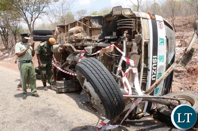 Northern Province Police Commissioner Richard Mweene with a ZANIS Ditrict Information officer Christen Muselu at the accident Scene along the Maba-Mpulungu road today, which has claimed 17 lives of the Catholic St Vincent De Paul group from Senga district.The Isuzu truck Reg No ACK 5871 was carrying over 60 people and carried off the road after losing the brakes.Several other people are admintted in Mbala and Mpulungu hospitals with critical conditions.Picture by Mary Bwembya (ZANIS)