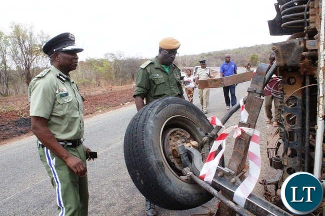 Northern Province Police Commissioner Richard Mweene with a ZANIS Ditrict Information officer Christen Muselu at the accident Scene along the Maba-Mpulungu road today, which has claimed 17 lives of the Catholic St Vincent De Paul group from Senga district.The Isuzu truck Reg No ACK 5871 was carrying over 60 people and carried off the road after losing the brakes.Several other people are admintted in Mbala and Mpulungu hospitals with critical conditions.Picture by Mary Bwembya (ZANIS)