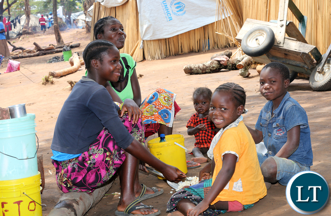 Congo DRC refugees family meal time at Kenani camp transit centre in the Nchelenge