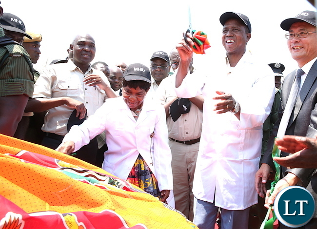President Lungu and chieftainess Nkomeshya and Chinese Ambassador to Zambia Yang Youming cutting a ribbon during the ground Breaking Ceremony for the Construction of Lusaka Specialized Hospital in Chongwe District on Tuesday, October 17,2017 -Pictures by THOMAS NSAMA President Lungu and chieftainess Nkomeshya and Chinese Ambassador to Zambia Yang Youming cutting a ribbon during the ground Breaking Ceremony for the Construction of Lusaka Specialized Hospital in Chongwe District on Tuesday, October 17,2017 -Pictures by THOMAS NSAMA