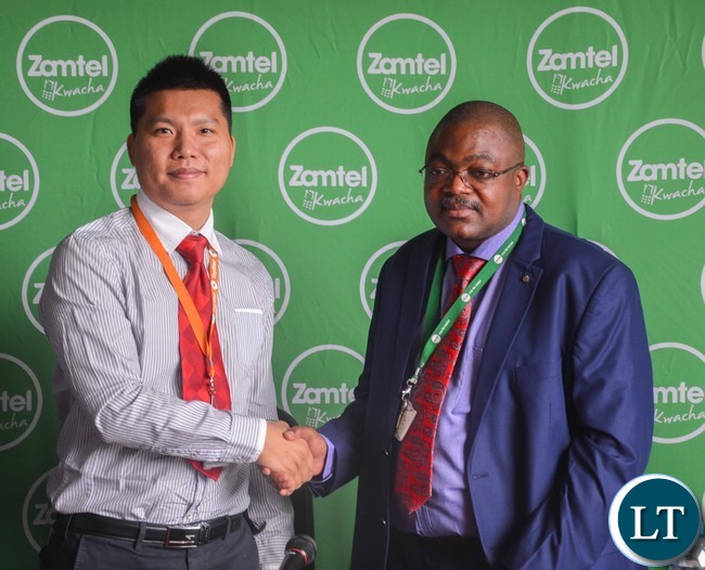 Zamtel Acting CEO Reuben Kamanga and TopStar CEO Leo Liao shake hands after the signing ceremony in Lusaka Zamtel Acting CEO Reuben Kamanga and TopStar CEO Leo Liao shake hands after the signing ceremony in Lusaka