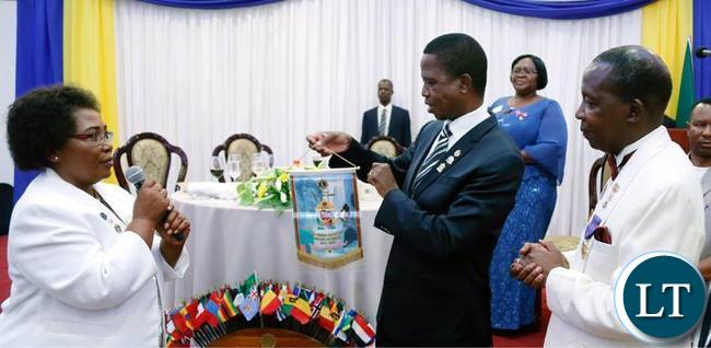 President Edgar Chagwa Lungu (cente) displays the badge he received from Lion 413 District Governor Jessica Chobe (left) on the right is Lions International Director Lion Hastings Eli Chiti during the Lion District 413 Zambia Fundraising for Melvin Jones Children Eye Referal Hospital at Pamodzi Hotel in Lusaka on Saturday,November 25,2017. SALIM HENRY/STATE HOUSE ©2017