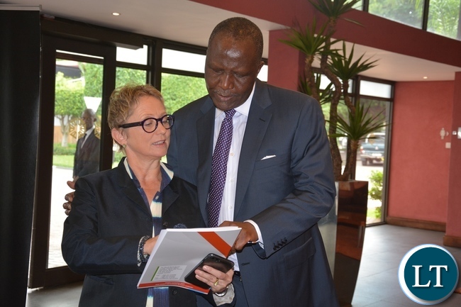World Bank Country Manager Ina Ruthenberg explains on the book called Zambia Economic Brief to Minister of Finance Felix Mutati shortly before the World Bank Launches of the tenth of Zambia Economic Brief at Pamondzi Hotel