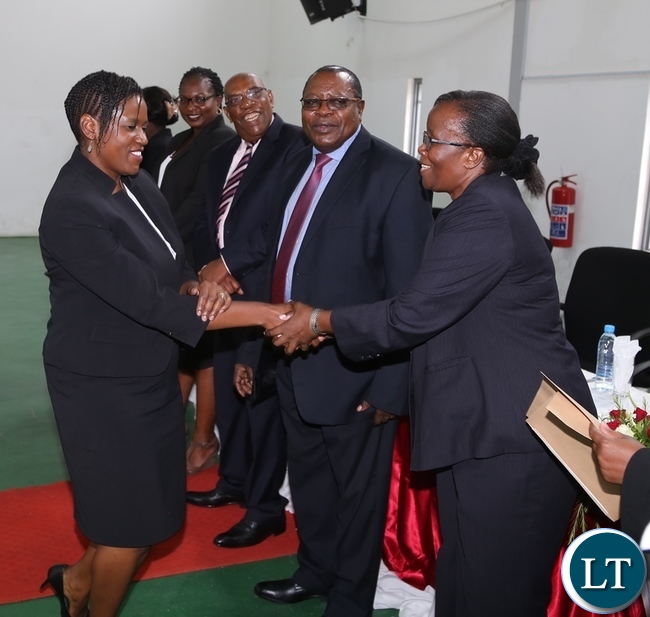 Zambia Institute of Advanced Legal Education (ZIALE) Lecturer Doris Mwiinga congratulates Sandra Wamulume during the post-graduate diploma in legislative drafting at ZIALE