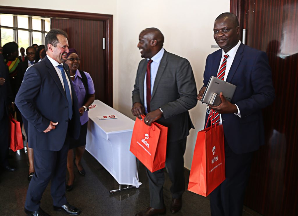 Airtel Chief Executive Officer Peter Correia confers with Ministry of Transport and Communication Director Communication Jese Bwalya (r) and ZICTA Managing Director Patrick Mutimushi (2nr) shortly after the launch of Airtel 4G network at Raddison Blu