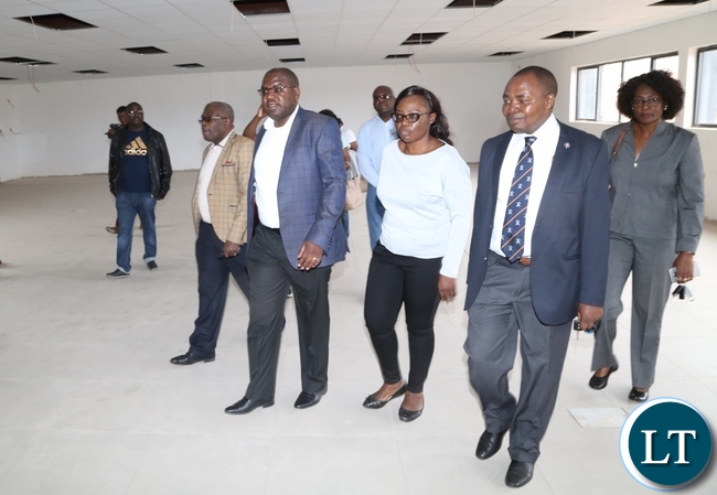 Minister of Health Chitalu Chilufya flanked by Permanent Secretary Cabinet office Stephen Mwansa (l) Levy Mwanawasa Hospital Medical Superintendent Dr. Lastone Chikoya (r) and (2nr) Levy Mwanawasa Hospital Director Physical planning Kakubelwa Mulalelo checking on the progress work at the lecturer theater Levy Mwanawasa Hospital