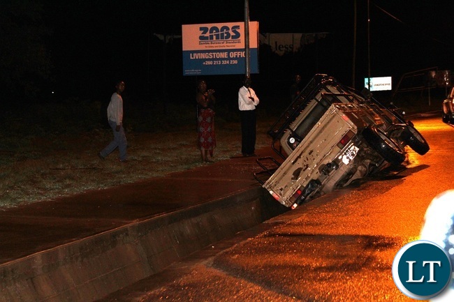 The driver of this vehicle escaped unhurt after the Toyota Landcruiser he was driving fell into the drainage due to over speeding along Lusaka road in Livingstone.Picture by KELVIN MUDENDA