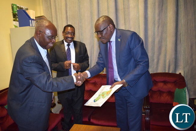 Minister of Tourism and Arts Hon. Charles Banda Banda receiving Barotse Maps from renowned archeologist and author Nicholas Katanekwa.