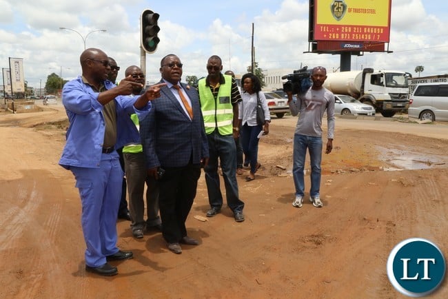 Special Assistant to the President for Project Implementations and Monitoring Andrew Chellah (l) with RDA member during the site visitation of the ongoing rehabilitation of Lumumba Road in Lusaka