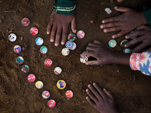 Children playing with bottle tops in the dust in Chowa township in Kabwe. The dust is highly contaminated with lead, which is extremely toxic. Photograph: Larry C Price for the Guardian Children playing with bottle tops in the dust in Chowa township in Kabwe. The dust is highly contaminated with lead, which is extremely toxic. Photograph: Larry C Price for the Guardian