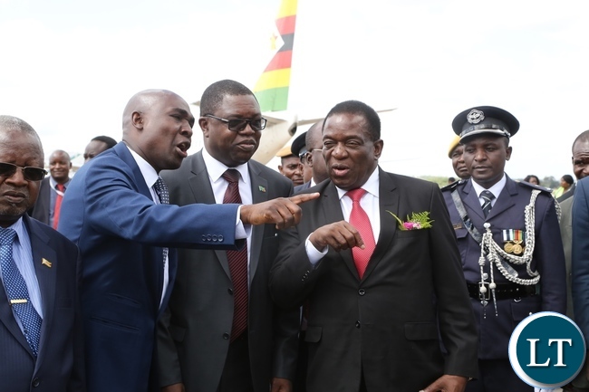 Lusaka Province Minister Japhen Mwakalombe and Minister of Foreign Affairs Joseph Malanji confers with President of Zimbabwe Emmarson Munagangwe shortly after his arrival at Kenneth Kaunda International Airport