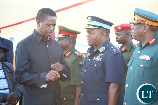 -President Edgar Lungu confers with Zambia Air Force Commander Lt. Gen. Eric Chimese shortly after his arrival from Muchinga Province at ZAF Lusaka Airport